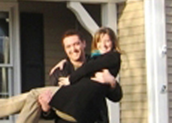 Happy couple in front of a house